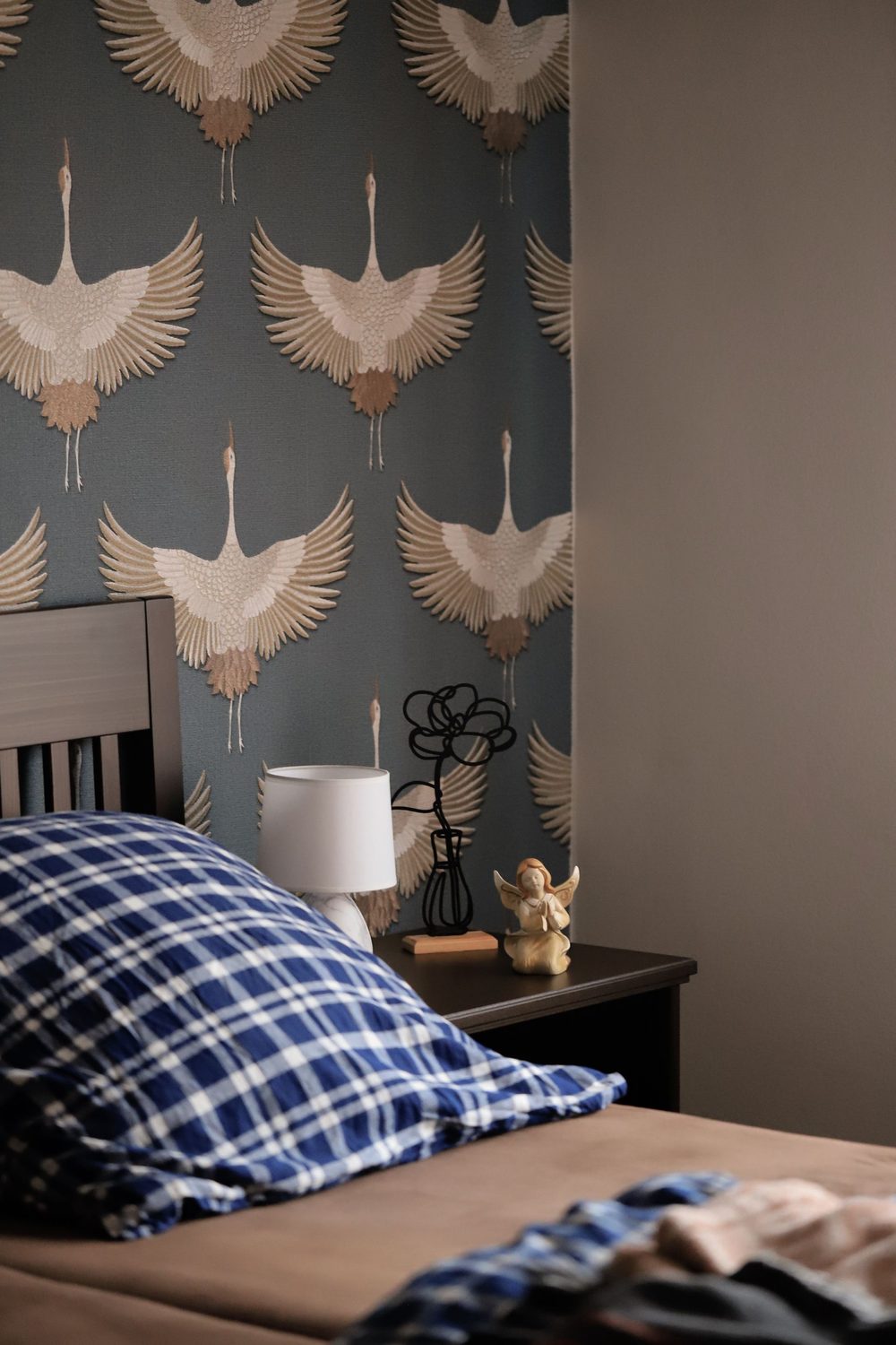 Contemporary bedroom with a soft-slate crane-motif wallpaper