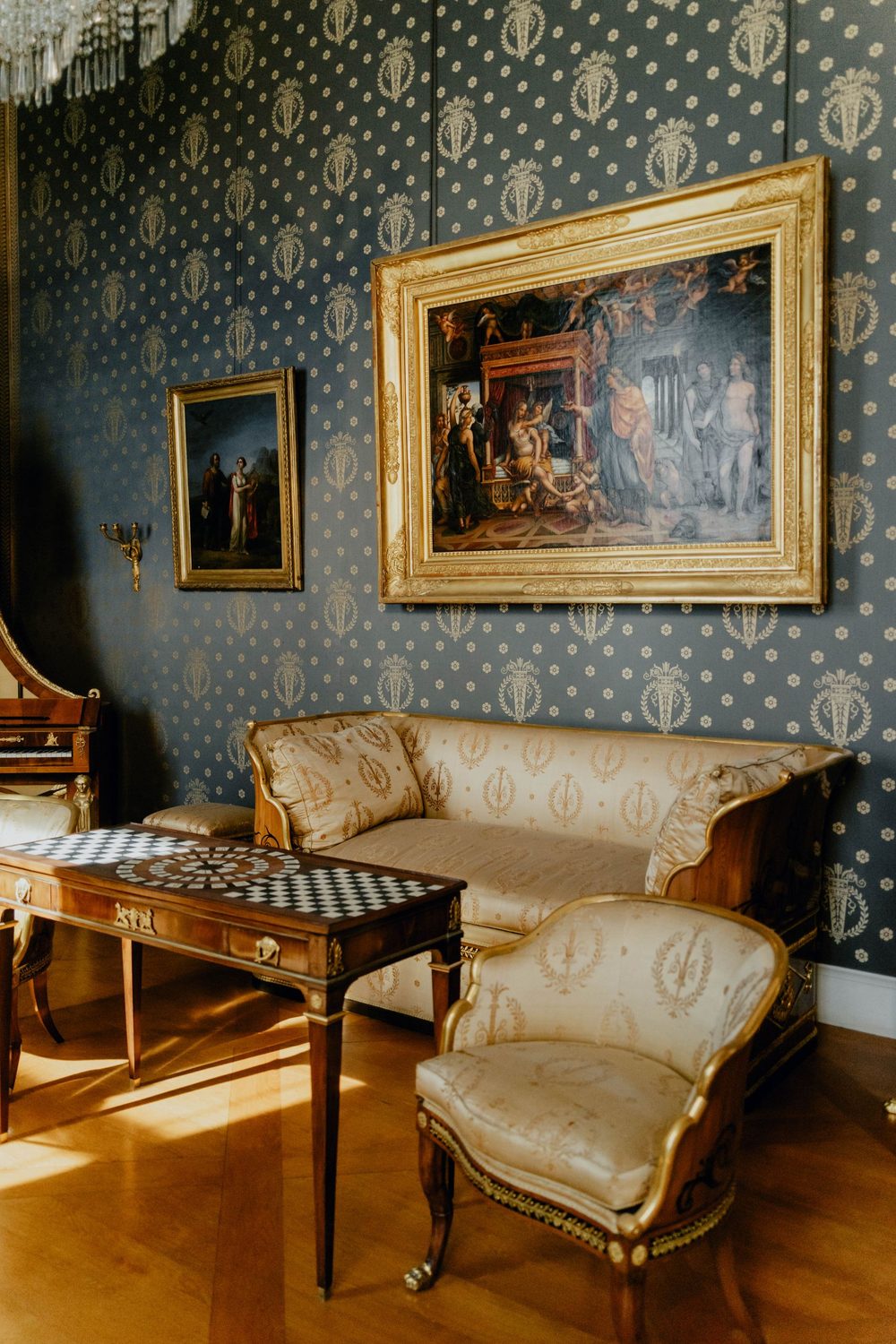Traditional sitting room in a blue-and-gold patterned wallpaper